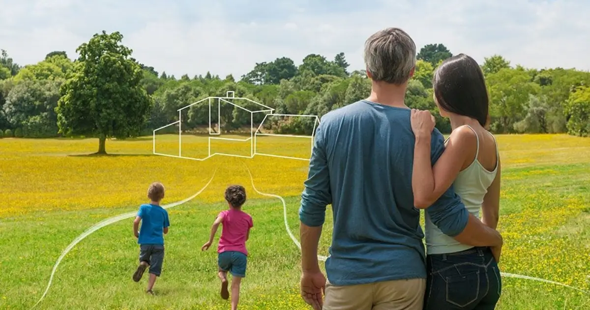 casal com filhos vendo terreno e imaginando casa construida